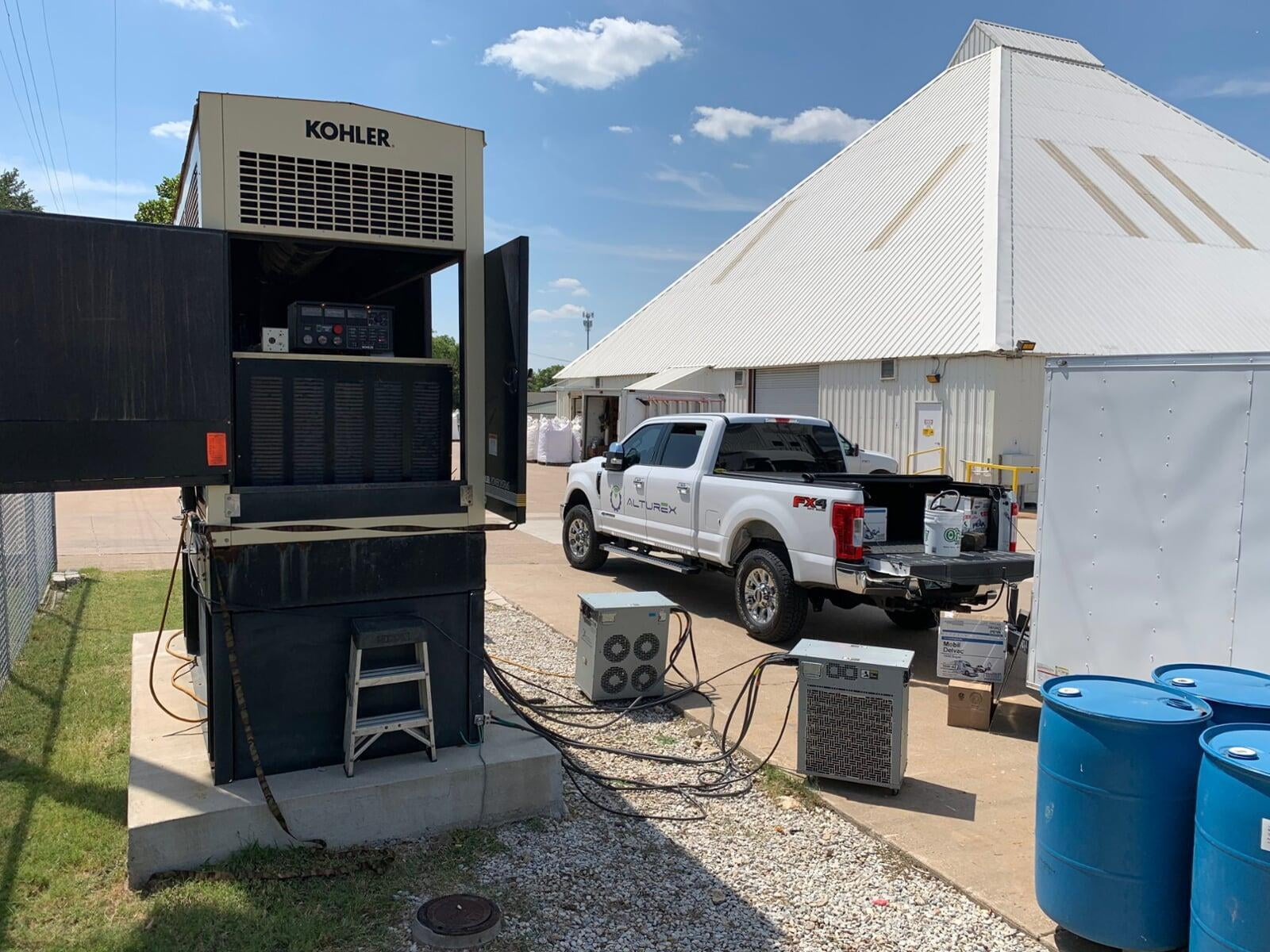 Alturex service truck parked beside an open Kohler standby generator during a service call